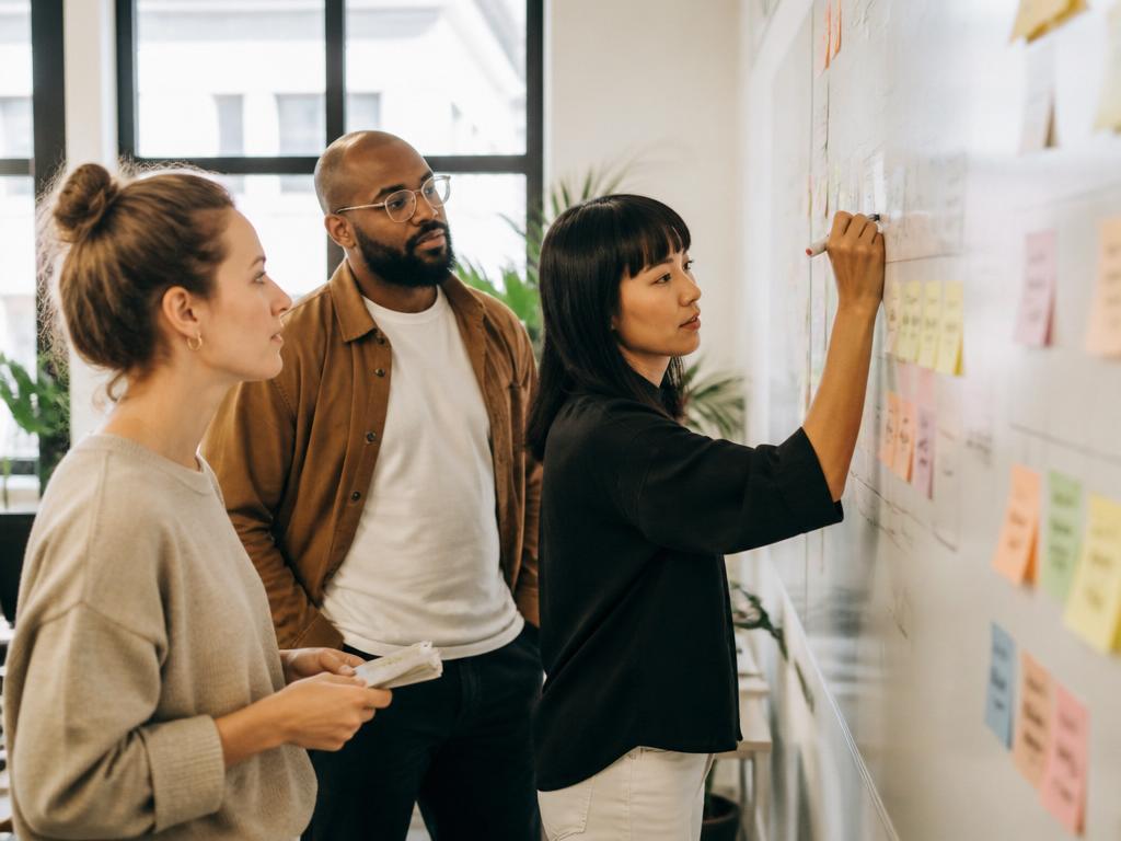Project team mapping work on a whiteboard